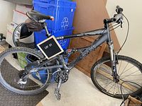 Side overview of black full suspension Weyless bike showing frame, wheels, saddle and surrounding area