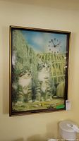 Framed wall clock showing two tabby kittens in a natural setting with clock display in top right corner.