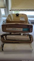 Ronson Carve N Slice Electric Knife in its brown base with white handle and cord