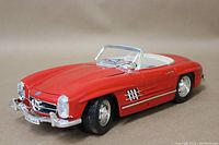 Front angle of the red 1957 Mercedes 300SL diecast model showing detailed grille, headlights, and bumper.