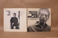 Photo showing the front covers of the two Bob Dylan LP albums: "Another Side of Bob Dylan" and "The Times They Are A-Changin'".