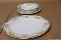 Large 16-inch oval platter with floral pattern and gold trim, showing side handles and detailing
