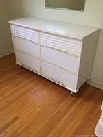 Full front view of Kilgour dresser showing 6 drawers with horizontal slats and yellow trim accents.
