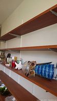 Wide shot of shelf showing metal owl and other decorative items