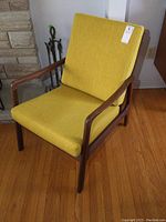 Front side angle view showing teak frame and chartreuse upholstery