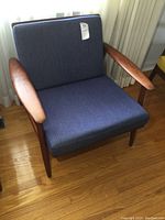 Front view showing seat cushion and back cushion in blue fabric on teak frame