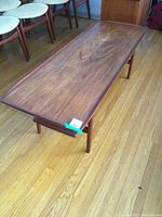 Full angled view of coffee table showing overall shape, tabletop and leg design