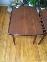 Top view of rectangular teak end table showing smooth surface with faint marks