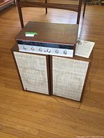 Full front view of receiver on top of two speakers