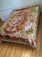 Full view of vintage plush throw spread on bed showing overall pattern and colors, fringe visible on edges.