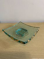Square aqua-tinted glass dish with 24k gold accents around edges and base, signed by Annieglass.