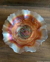 Top view of ruffled carnival glass bowl showing Apple Blossoms pattern and rainbow iridescence