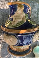 Cobalt blue pitcher with cherub and shell motif in majolica style