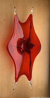 Top-down view of red Murano glass centerpiece with clear tips, showing overall shape and condition.