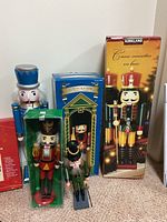 Nutcracker figurines of various sizes and packaging boxes showing brand Kirkland and 25 inch height marking