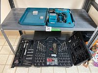 Jobmate tool set in black plastic case, containing multiple hand tools including hammer, pliers, wrenches, screwdriver bits and sockets.