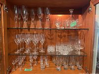 Full cabinet view showing all glassware on three shelves