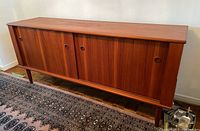 Front view of teak buffet showing two sliding doors and circular recessed pulls