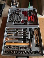 Full view of Vanadium tool set in gray plastic case containing ratchets, sockets, pliers, screwdrivers, hammer, and hex keys.