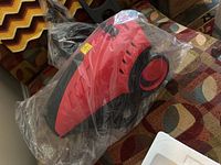 Main unit of the Costway high pressure cleaner wrapped in clear plastic.