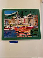 Rectangular painted glass artwork with green border showing a detailed colorful harbor scene with multiple boats, buildings, and water reflections.