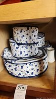 Stack of fabric storage bags with blue floral print, likely for storing china pieces
