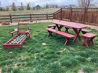 Full view of the outdoor furniture set including picnic table, benches, stools, and chaise lounge on grass in backyard.