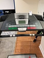 Top view of ProForm treadmill control panel showing digital readout screen, start and stop buttons, and various function keys.