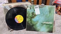 Photo of vintaged vinyl LP 'Moonlight Becomes You' by The Moonlight Strings with record partially out of sleeve and visible label 'Display'