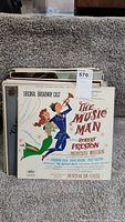 Stack of vintage LP records showing the top record titled 'The Music Man' original Broadway cast album.