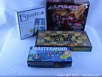 Photo showing all four board games stacked and visible: Equate, Khet 2.0, Check Math, Mastermind for Kids.