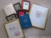 Photo showing multiple assorted picture frames including 11x14 and 14x18 ClassicWood frames with gold trim as well as smaller frames and photo album in new condition.