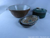 Overview photo showing all pottery items: mixing bowl, two bakers, and casserole with lid