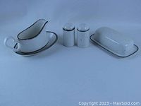 Full view of set including covered butter dish, gravy boat with underplate, and salt and pepper shakers arranged together.