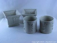 Photo showing two round and two square white/off-white vintage porcelain planters with decorative raised designs