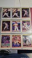 Binder page with nine 1991 O-Pee-Chee Premier baseball cards showing players in various batting and fielding poses, with black and gold borders and player names.