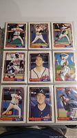 Nine 1992 O-Pee-Chee MLB baseball cards showing players in different baseball poses and some portraits, placed in clear sleeves inside a binder page.