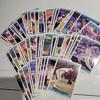 Photo showing over 40 Donruss 1992 baseball cards spread out on a flat surface including players Joe Carter, Kirby Puckett, Roger McDowell, and Curt Schilling.
