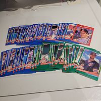 Photo showing over 40 1991 Donruss Cleveland Indians baseball cards spread out on a white surface. Cards have blue, red, and green borders and feature various players.