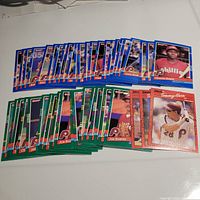 Photo showing over 40 1991 Donruss baseball cards featuring Philadelphia Phillies players with blue, green, and red/orange borders laid out on a white surface.
