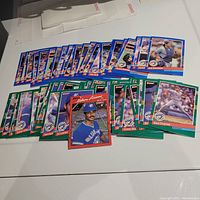 Image showing over 50 1991 Donruss Toronto Blue Jays baseball cards spread out on a white surface, including blue and green bordered player cards and one red bordered card.