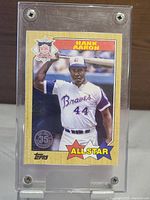 Front side of the Topps 35th Anniversary Hank Aaron All Star baseball card showing Hank Aaron in Braves uniform with batting pose, card encased in plastic holder.