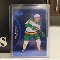 Photo of 2021-2022 Metal Universe Kirill Kaprizov hockey card in protective sleeve showing player's image and card details.