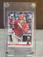 Front of Shohei Ohtani Topps All Star Rookie baseball card in a hard case showing the player batting in Angels uniform, with Topps logo and All Star trophy icon.