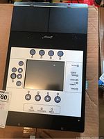 Front view of the Desigo alarm panel showing the screen, buttons, and status indicator labels.