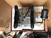 Siemens vacuum pump showing metal body with fittings and packaging.