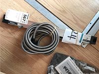 Mitutoyo Absolute Linear Scale AT715 showing the coiled metal protective cable and scale base.