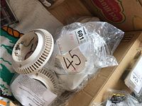 Five Siemens fire safety audible bases in white plastic, some wrapped in plastic bags with labels.