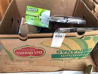 Photo of box containing Swiffer Sweeper kit alongside storage bags and other household items