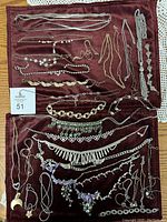 Full lot of assorted antique-style necklaces and bracelets displayed on velvet fabric.